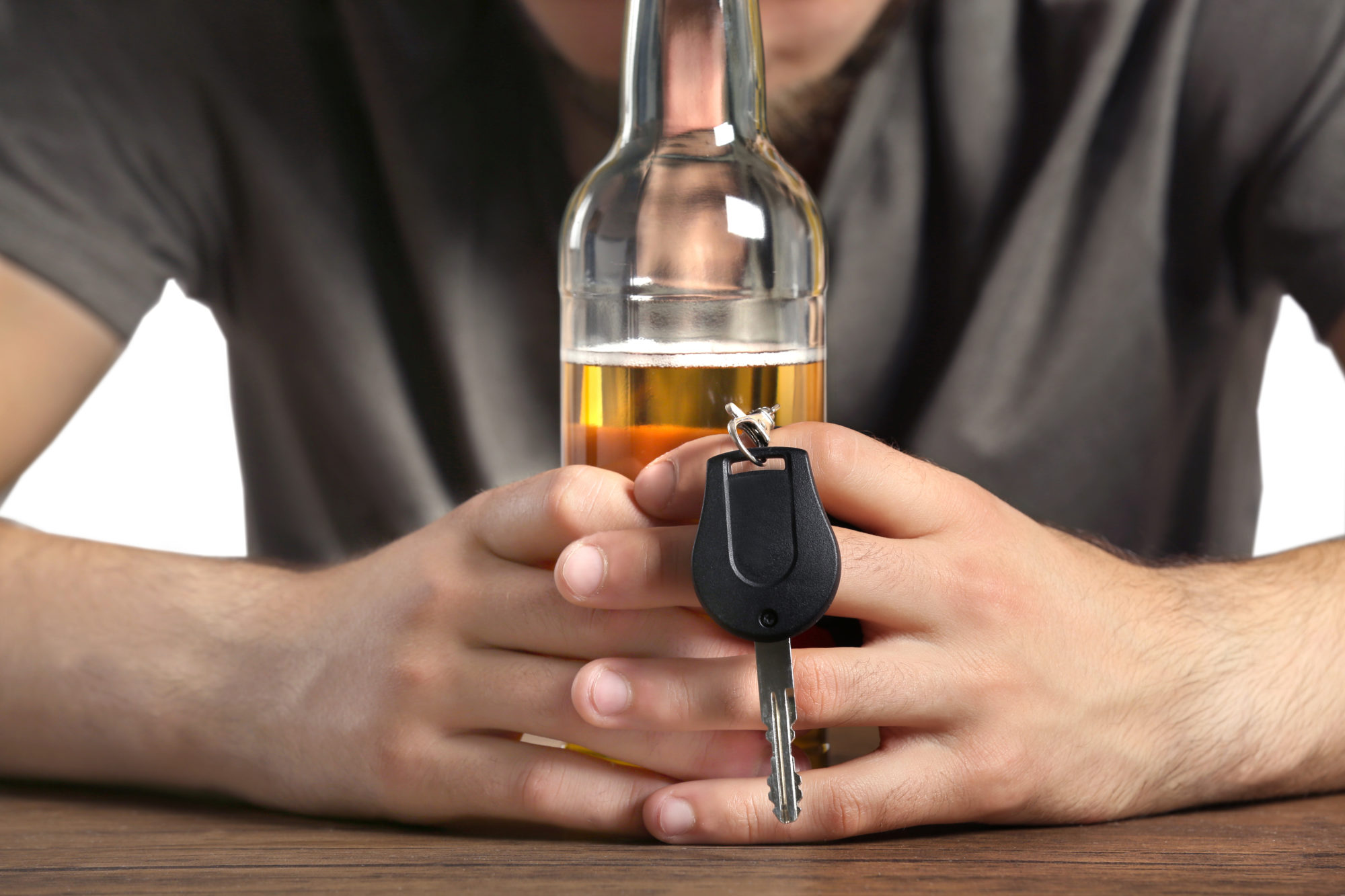 Close Up View Of Male Hands With Bottle Of Beer And Car Key